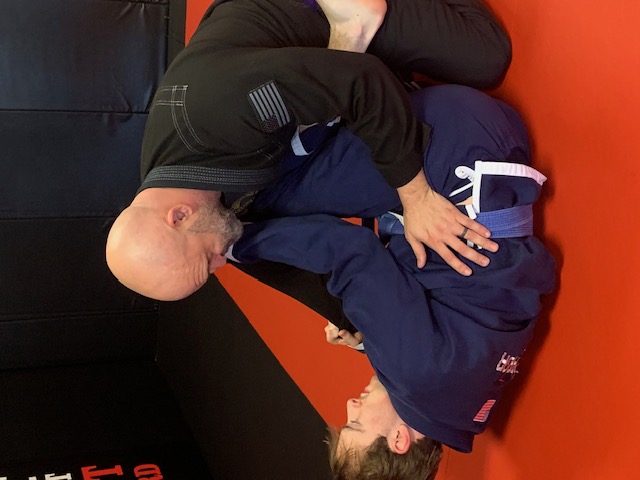 Adult BJJ fundamentals class training in gi at Warrior Academy Kennesaw